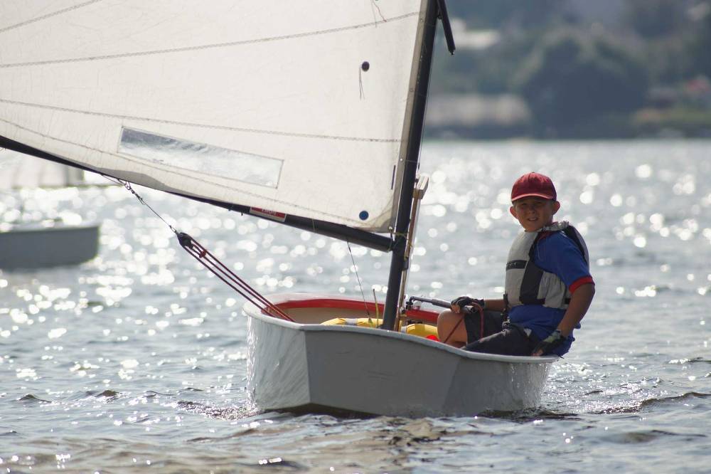A young boy sails alone on Trevassack Lake
