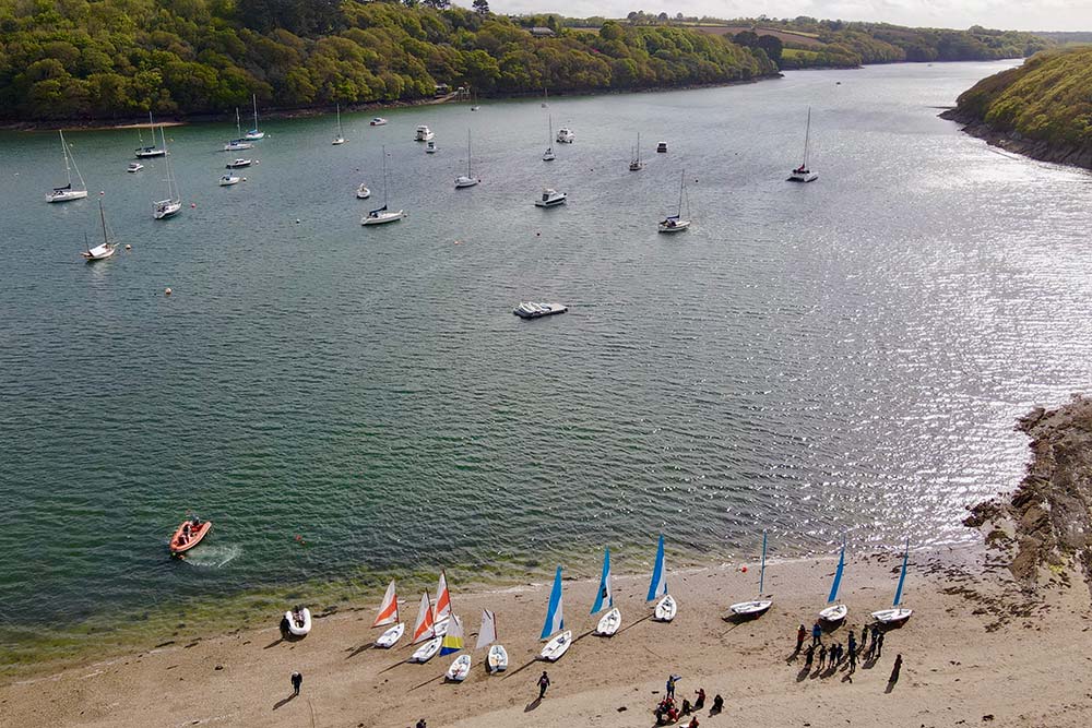 Aerial view of sailing dinghies on Helford River beach