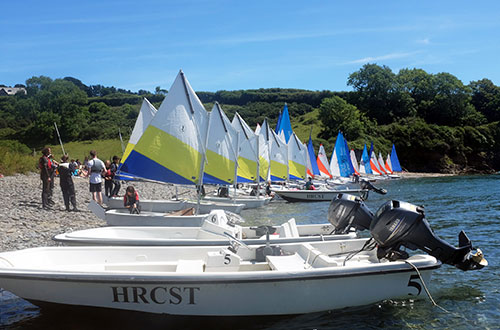 A selection of sailing and powerboats on the beach for CST Experiences