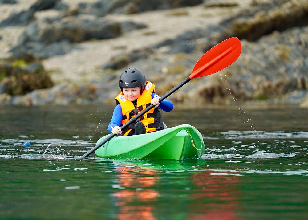School child in a kayak